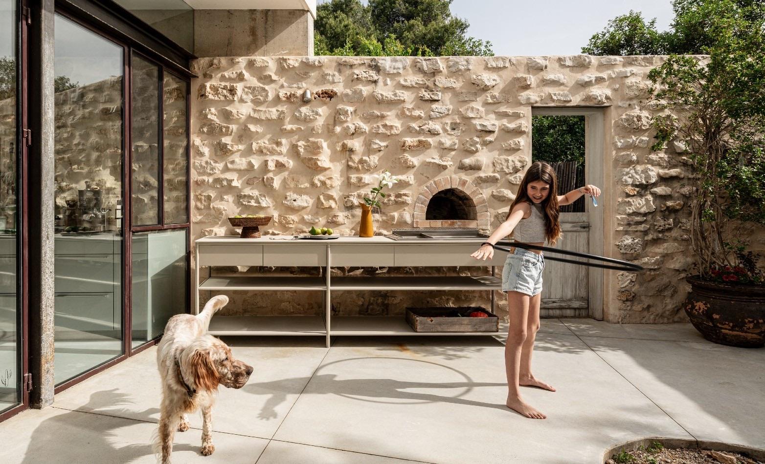 CSL console with pizza oven, girl and dog in courtyard