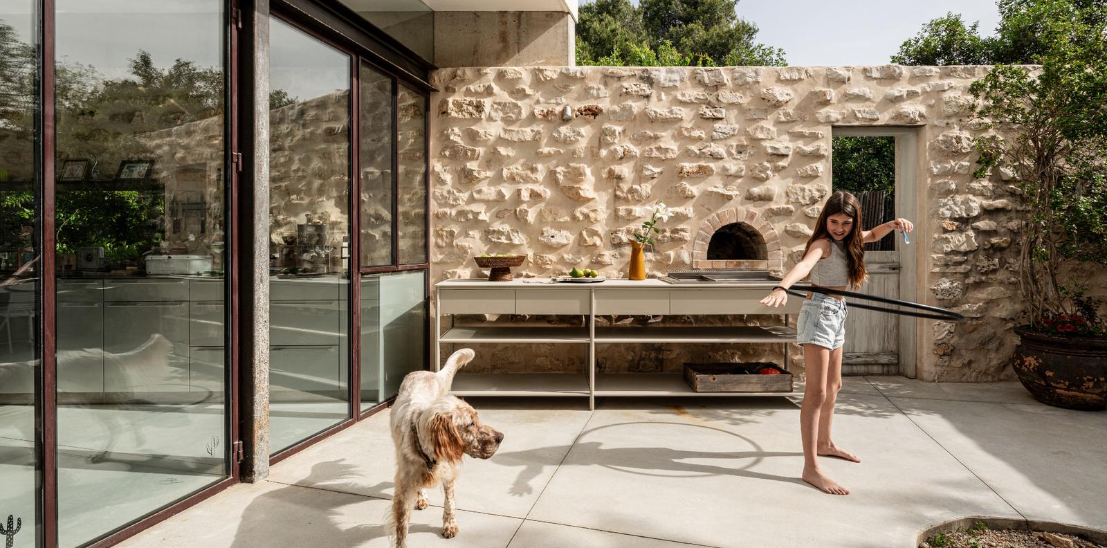 CSL courtyard kitchen with children and dog