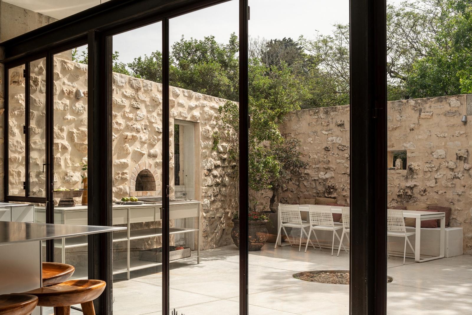 CSL kitchen with wooden stools in a courtyard