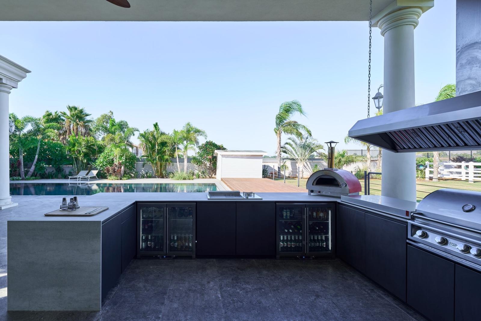 Custom U-shaped Capo Cuòco outdoor kitchen specified for a custom home build